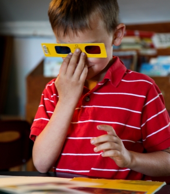 Button to Enrol in Home Learning, Child Reading with 3D Glasses